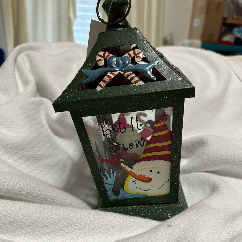 New! Metal Let it Snow lantern. Holds a tea light candle.